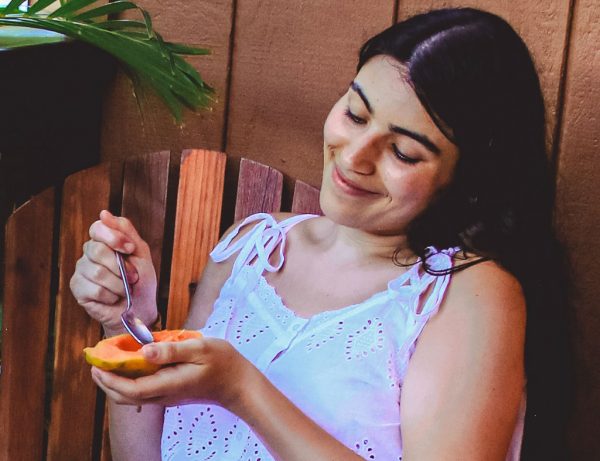 woman eating papaya